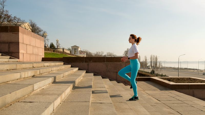 Young woman running on city streets