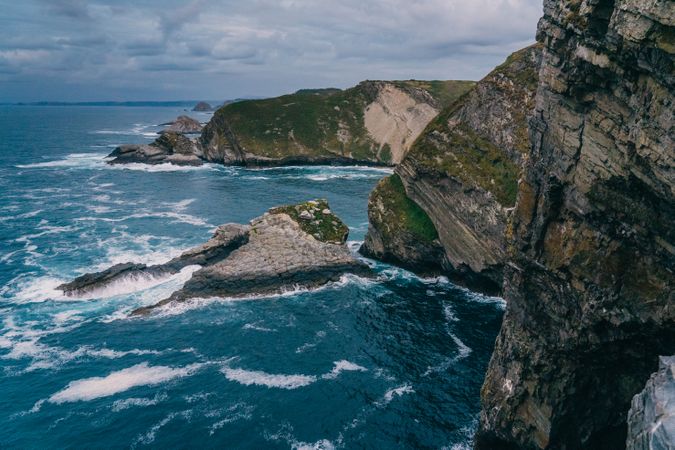Sea waves crashing near cliff