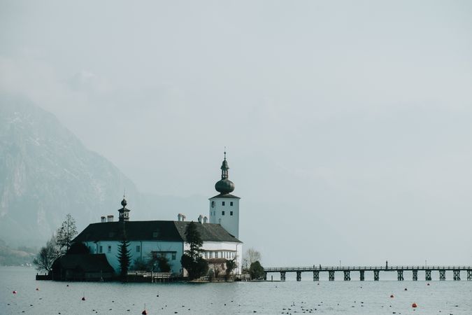 church in calm water surrounded by mountains