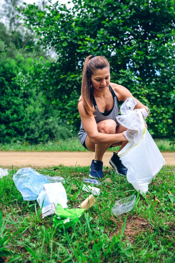 Woman with garbage bag doing plogging