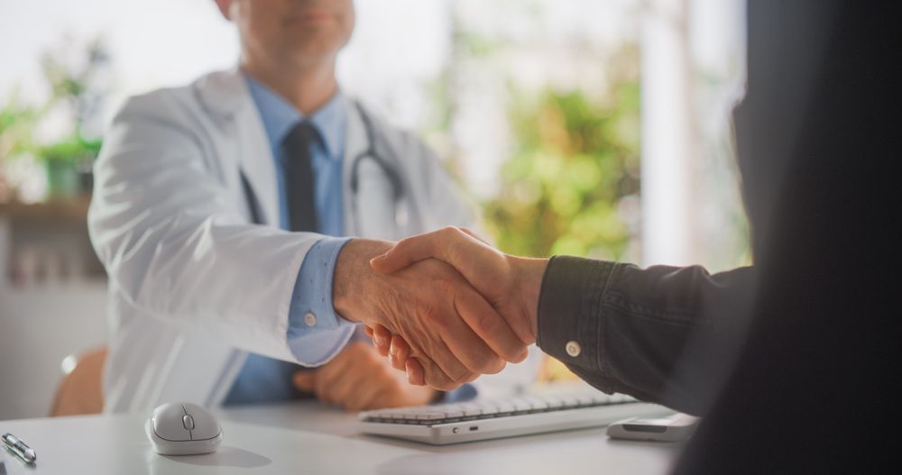 Close Up on Doctor's Hands Explaining Medical Test Results to a Patient During a Health Check Visit