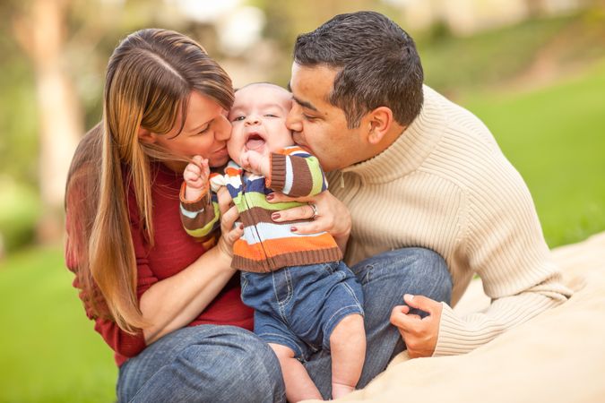 Happy Family Having a Picnic and Playing In The Park.