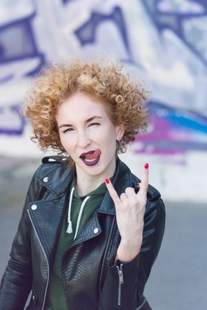 Portrait of fashionable female with curly hairstyle and violet lipstick