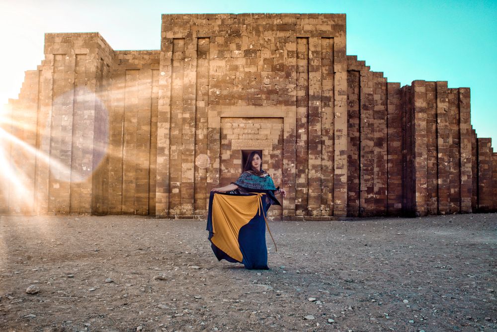 Woman standing beside pyramid of Djoser in Giza, Giza Governorate, Egypt