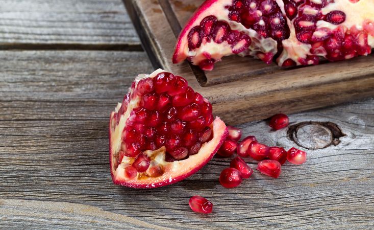 Juicy ripe pomegranates aged wood