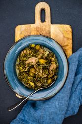 Chakapuli is a Georgian stew on blue plate