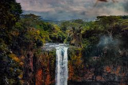 Waterfall surrounded by colorful rocks and vegetation