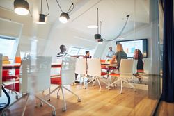Group of people sitting at a meeting in an open modern office