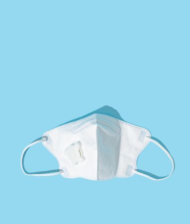 Respiratory or surgical face mask with baby blue background