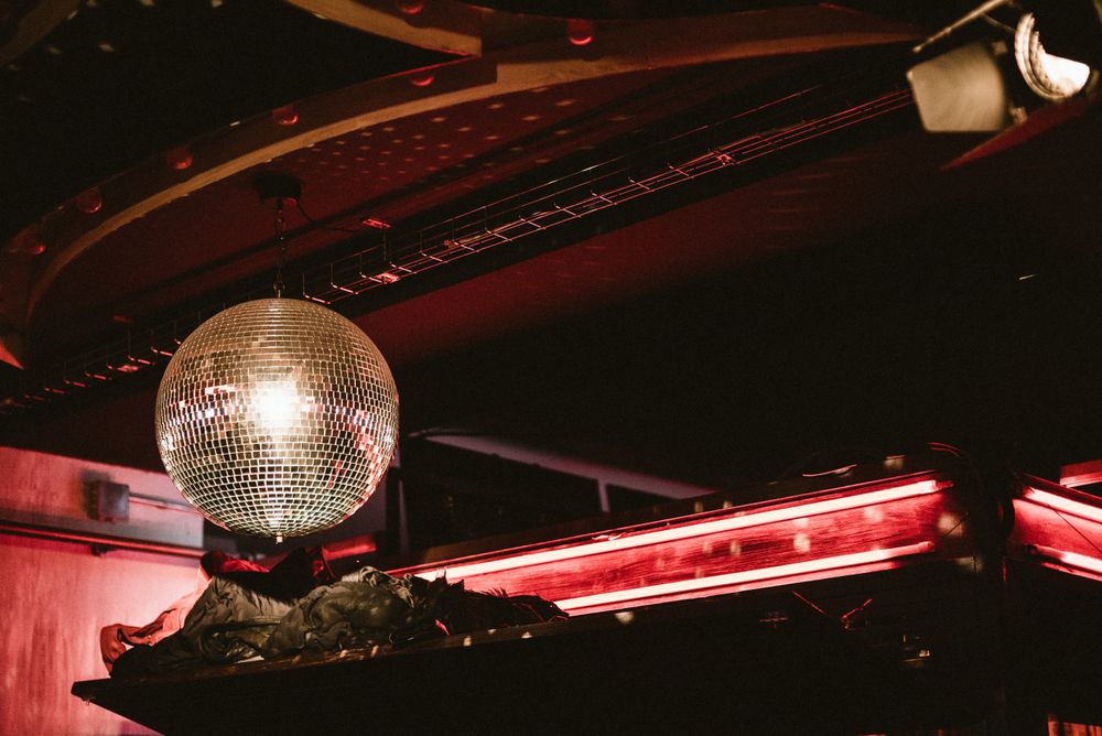 Ceiling mirror ball in dark club with red light