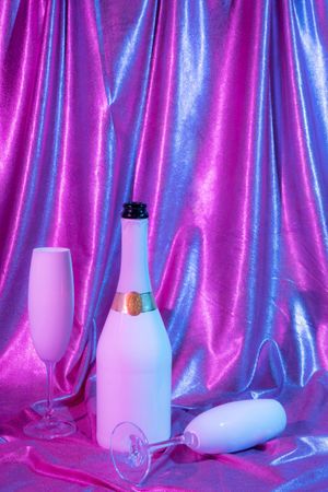 Holographic abstract pastel colors backdrop with Champagne bottle, vertical composition