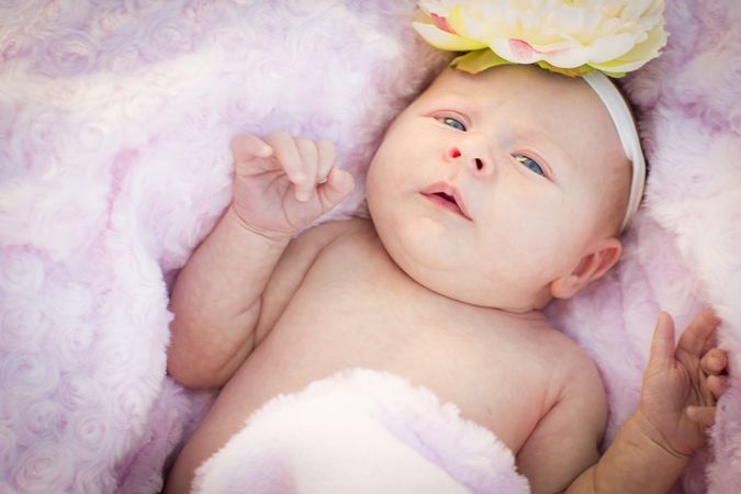 Tiny Newborn Baby Girl Laying in Soft Blanket