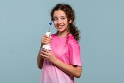 Girl posing with an oral irrigator