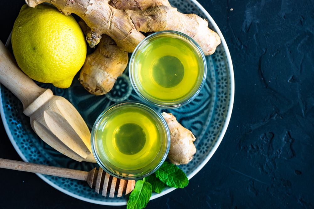 Top view of detox drinks with lemon, ginger and mint with copy space