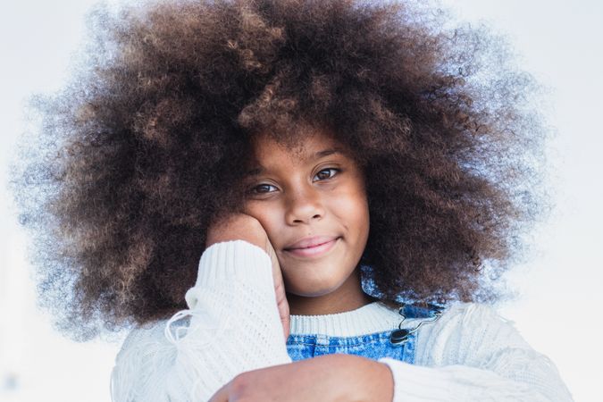 Smiling Black teen girl with curly hair