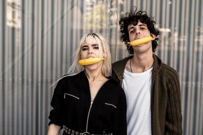 Couple covering faces and feelings under fake mask of joy