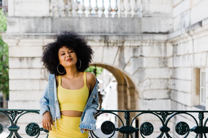 Stylish female leaning on railing outdoors