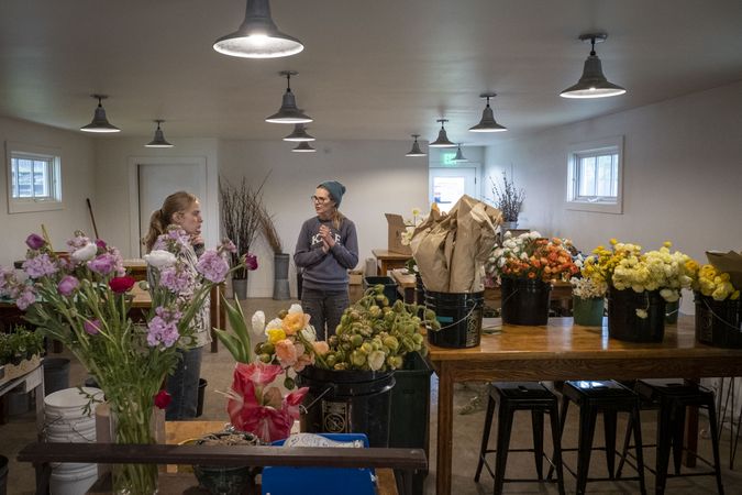 Copake, New York - May 19, 2022: Two women talking in flower shop