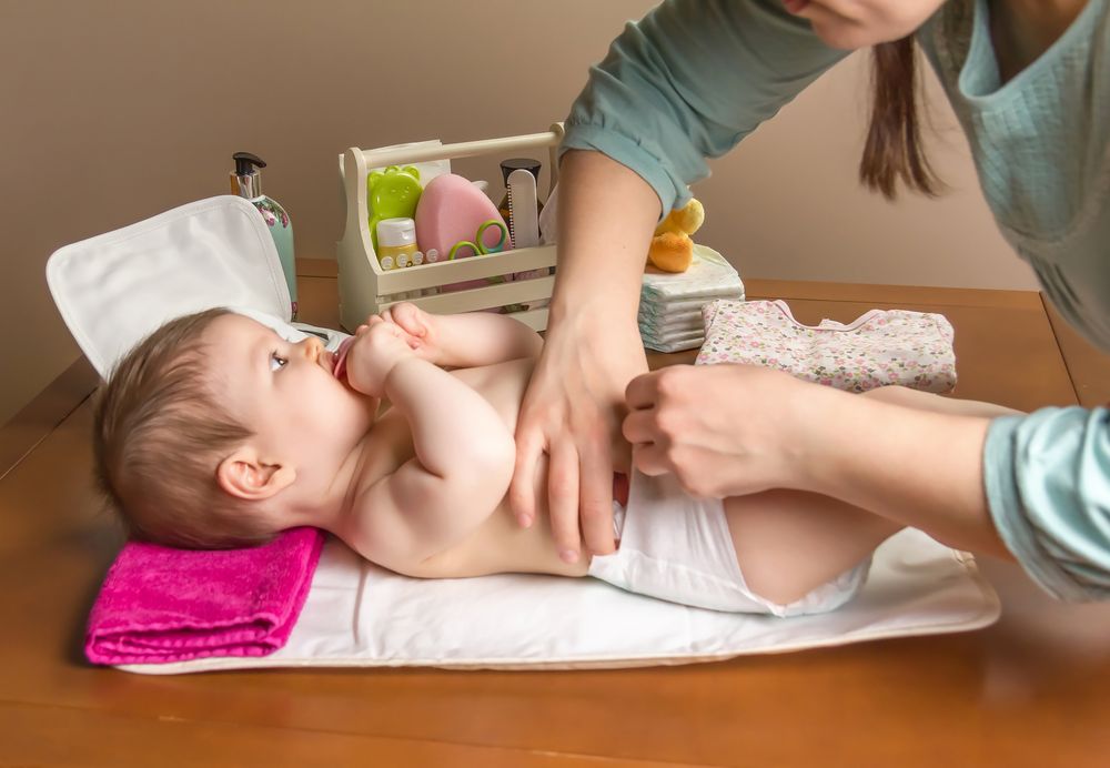 Parent wrapping diaper of baby