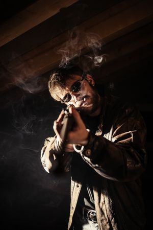 Man with shotgun and cigarette