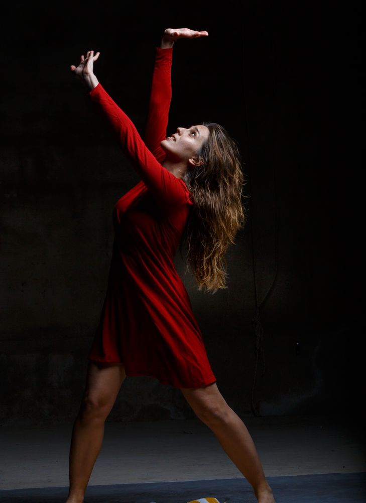 Young woman dancing in darkness