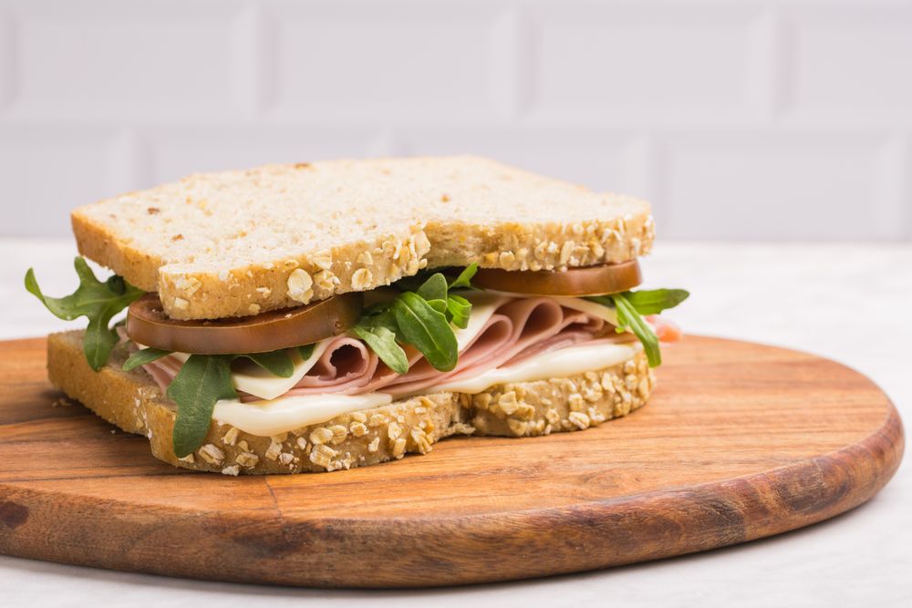 Delicious sandwich with ham, cheese, lettuce and tomato