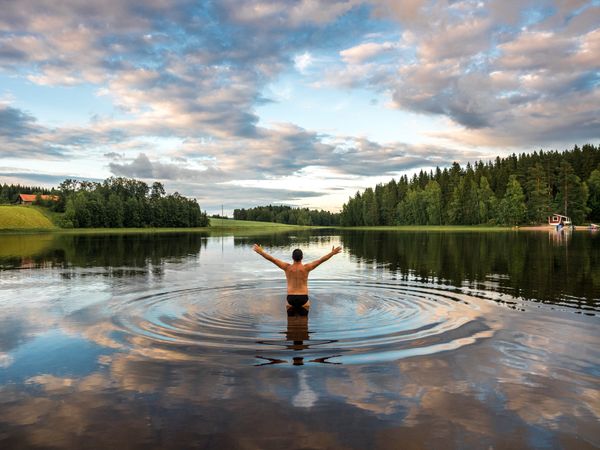 Man standing in water with opening hands