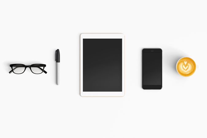 Modern workspace with coffee cup, smartphone, paper, notebook and tablet copy space