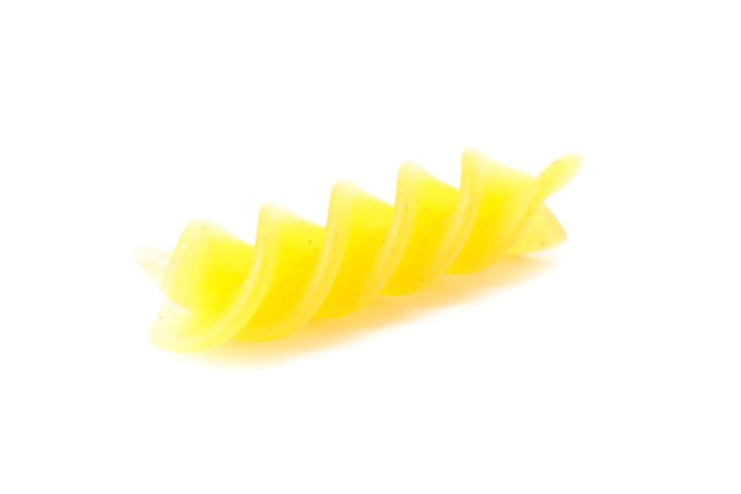 Pasta isolated on light background, closeup. Dry raw whole pasta