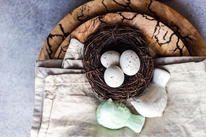 Top view of Easter table setting with bird figurine and nest on table