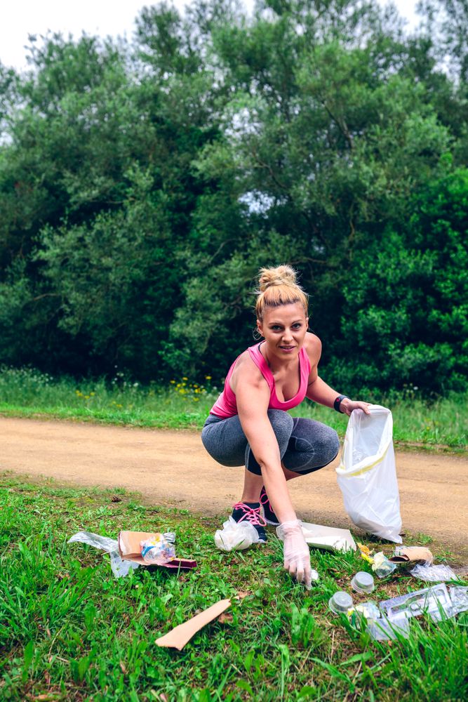 Woman picking up trash doing plogging