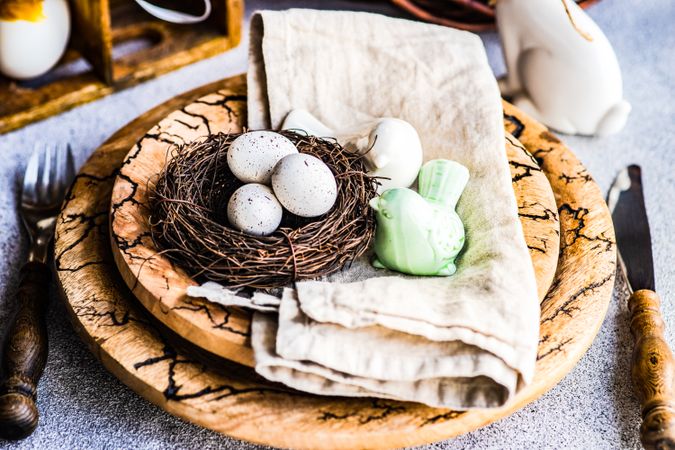 Easter table setting with bird figurine and nest on table