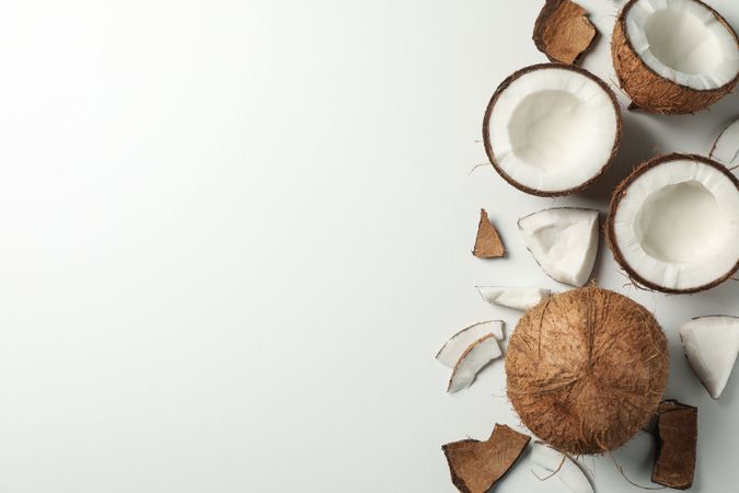 Coconut on plain background, top view and space for text