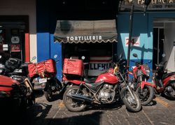 Awning of tortilleria with motorbikes parked outside