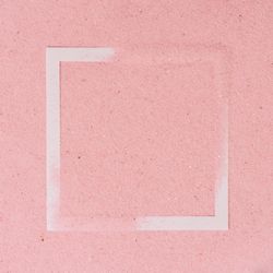 Pink sand covering parts of paper square outline