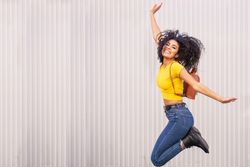 Joyful female jumping outside, copy space