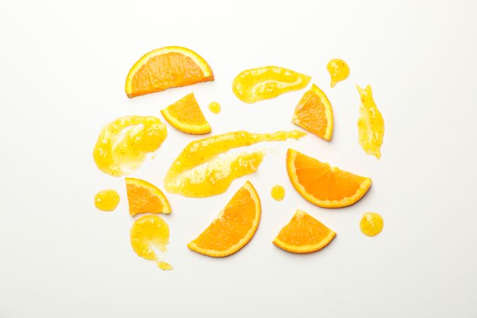Composition with orange slices and jam on blank background