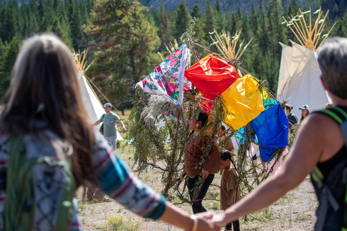 Montana, United States - August 17, 2022: People holding hands in circle centered on Native American traditions in Yellowstone