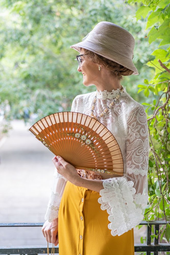 Woman with retro fan in park