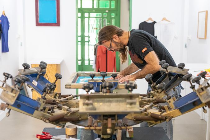 Artist printing screen in workshop