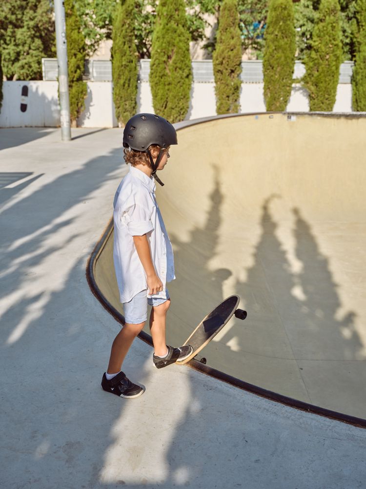 Boy with longboard on ramp edge