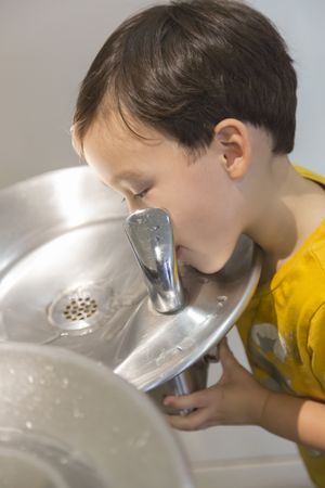Boy Drinking From the Water Fountain