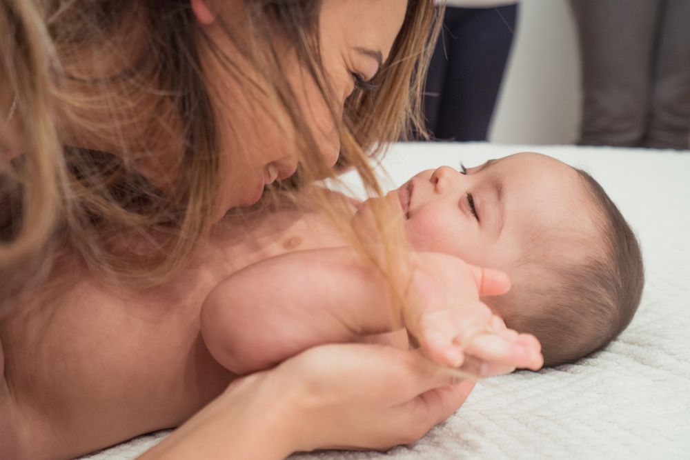 Portrait of cute baby boy with Down syndrome and his mother