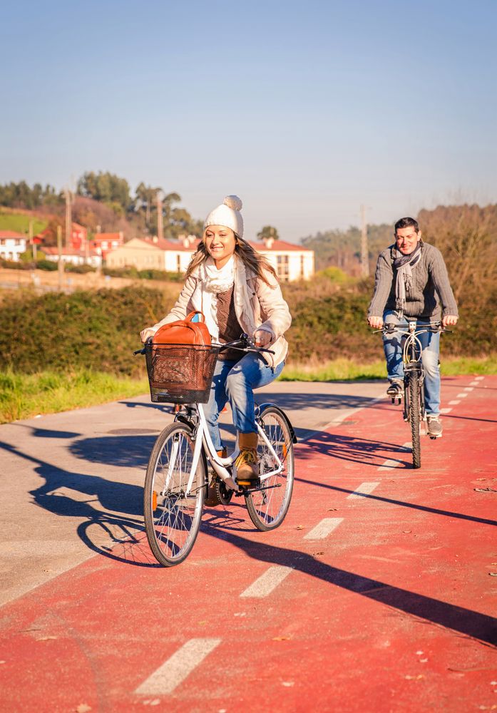 Front of man and woman in bike lane on family ride