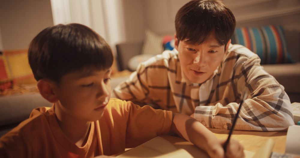 Portrait of Smart Young Boy Doing Homework with Helpful Father Teaching Him Math, Science, Geometry.