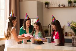 Family sharing gifts and joy during birthday celebration at home.