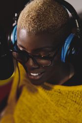 Smiling Black woman in headphones near mic