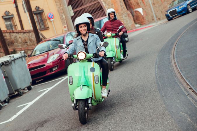 Young people riding motorcycles on city road