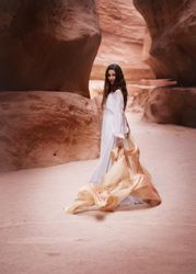 Woman standing in naturally formed alley in Jordan