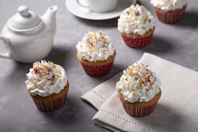 Tasty party cupcakes on the table. Cupcakes with whipped cream.